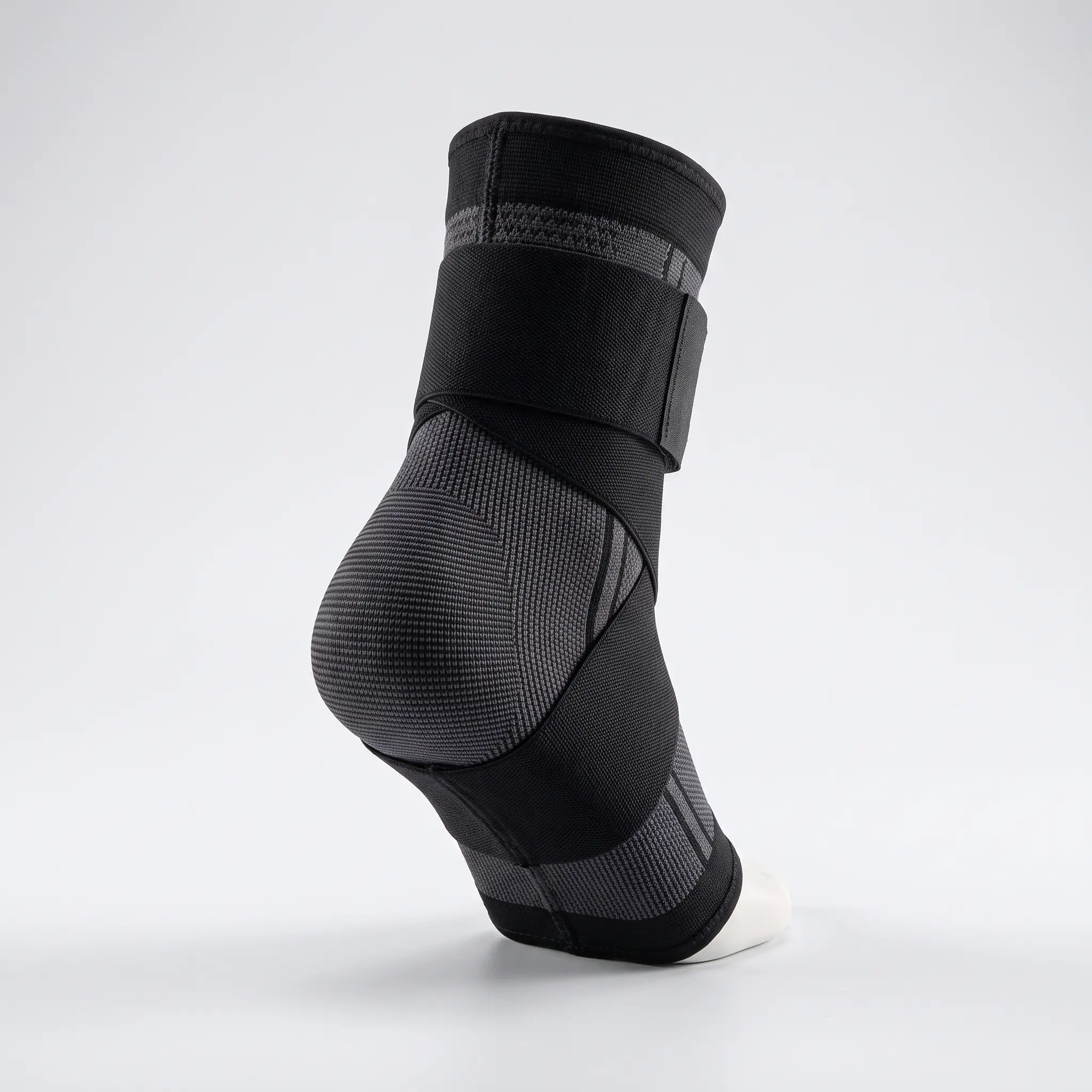 Black KnitPair knitted sleeve showing its closed heel, open toe and adjustable wrap strap.
